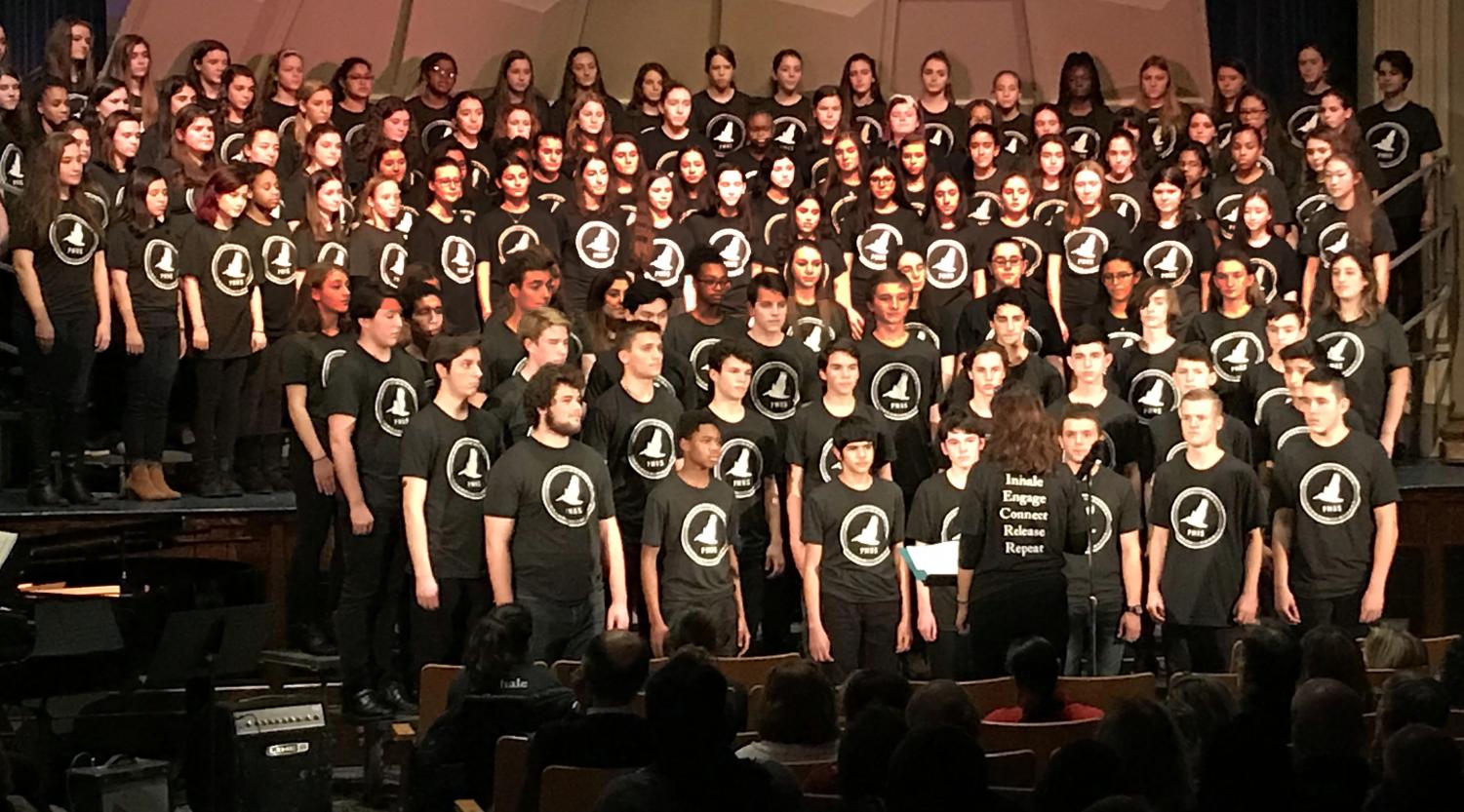 Choral Director Mrs. Maria Abeshouse leads the choir in a program of pop and Broadway songs at the fundraiser.