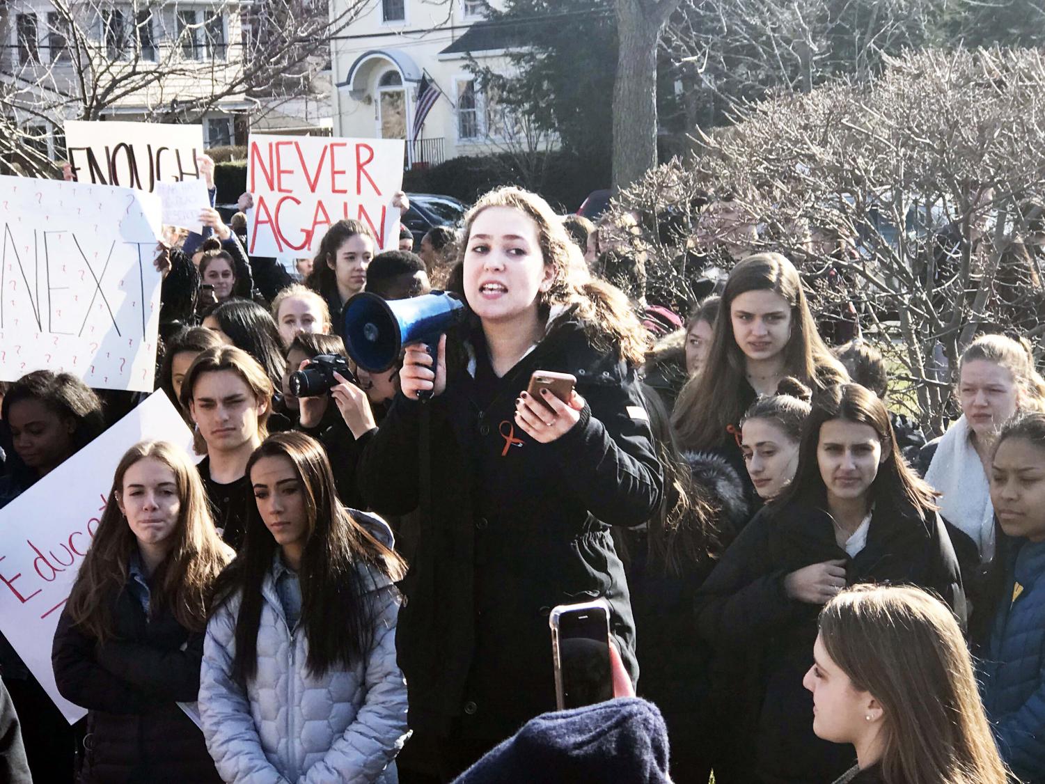 Student Leana Rutt addresses a crowd of over 200 students who participated in the walkout in support f school safety.