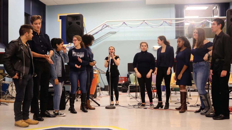 The Acapelicans warm up in Cafeteria C before their premiere performance at the stage band fundraiser on November 8.