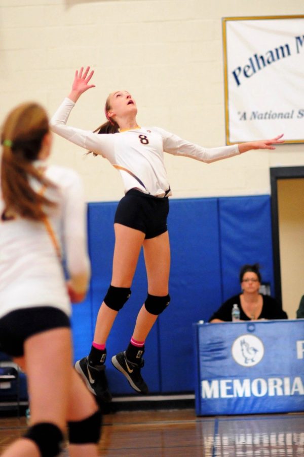 Senior Charlotte Krause spikes the volleyball.
