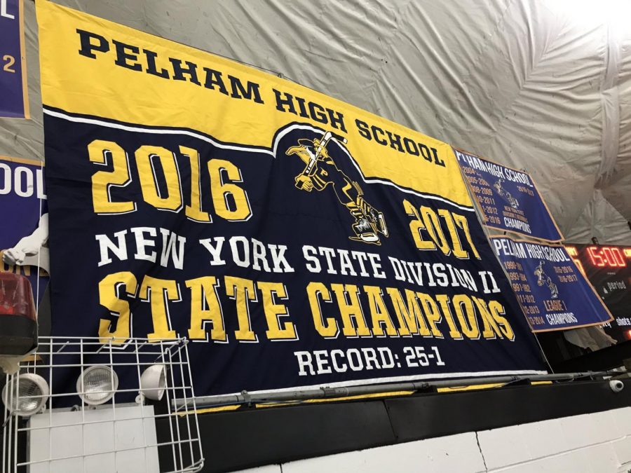 The  PVP team state championship banner is raised at the Ice Hutch Arena.