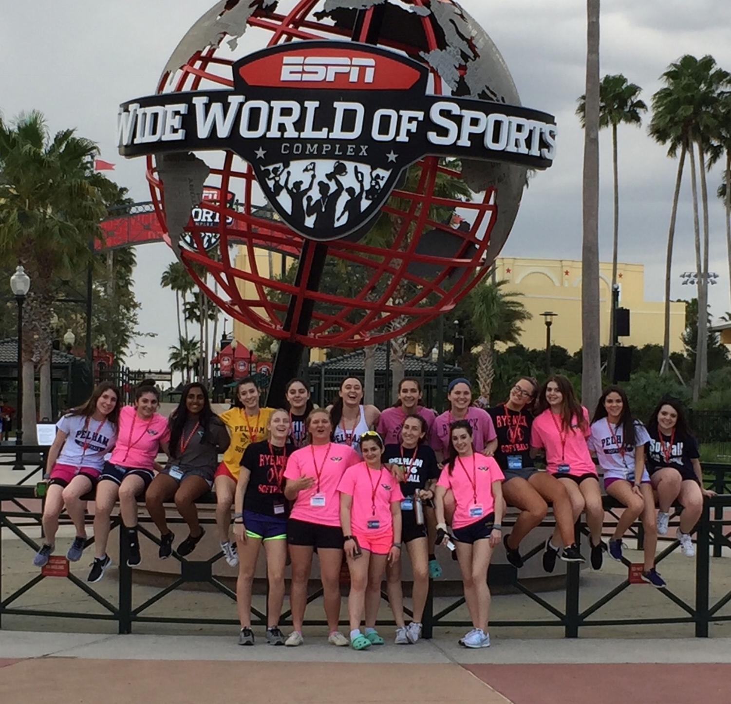 The varsity girls softball team gathers in front of the sports complex at Disney World.