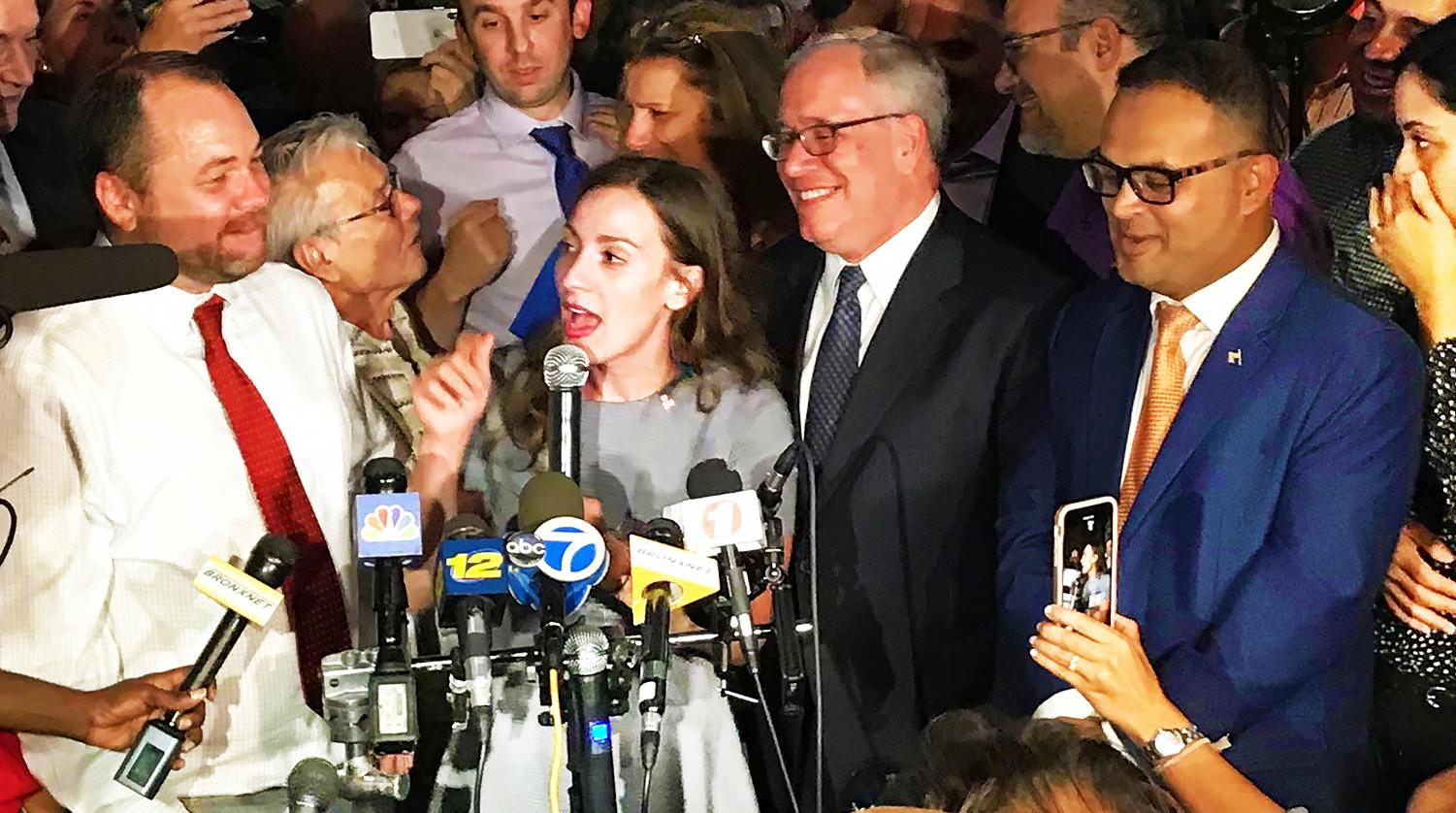 Alessandra Biaggi (c) responds to reporters following her win as the Democratic nominee for New York Senate in District 34.
