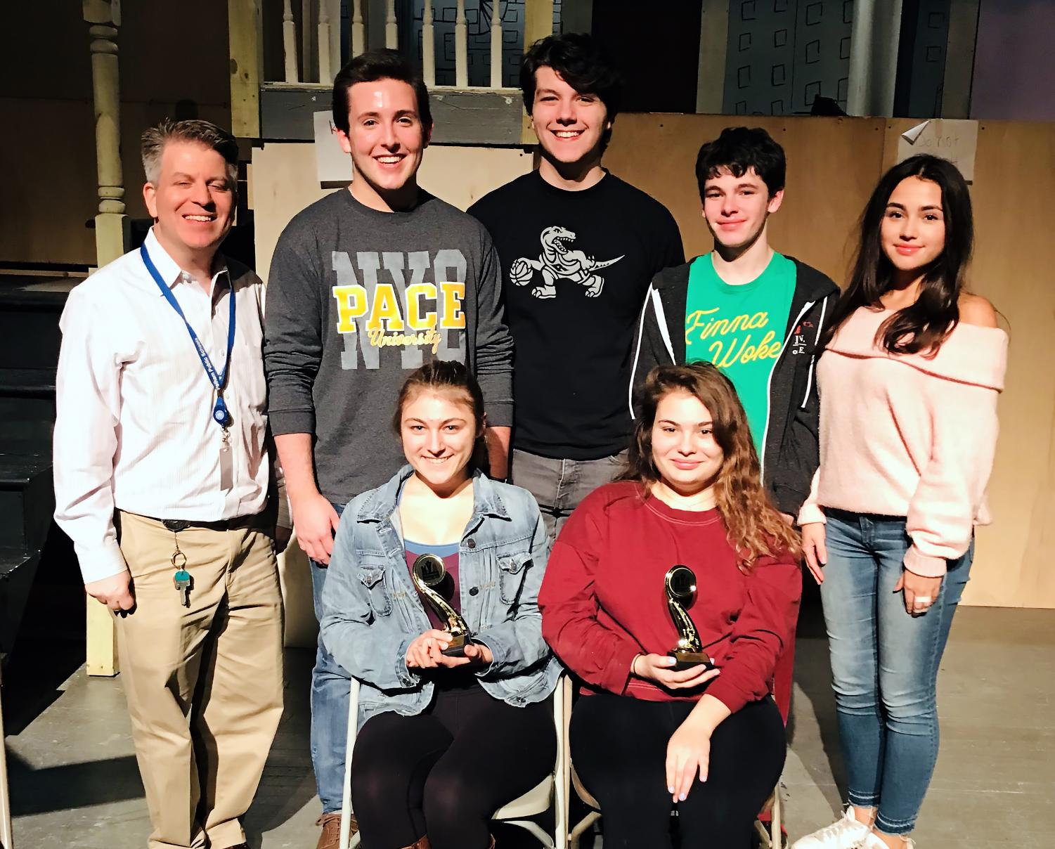 On the set of SnB’s, “Brighton Beach Memoirs,” Mr. Beck (back row, far l) celebrates the club’s recognition with (back row, l to r): seniors Jack Hopkins and senior Sam Rodd, juniors Jack Finegan and Camilla O’Keefe, and (front row, l to r) seniors Maggie Solimine and Athena Woodfin.