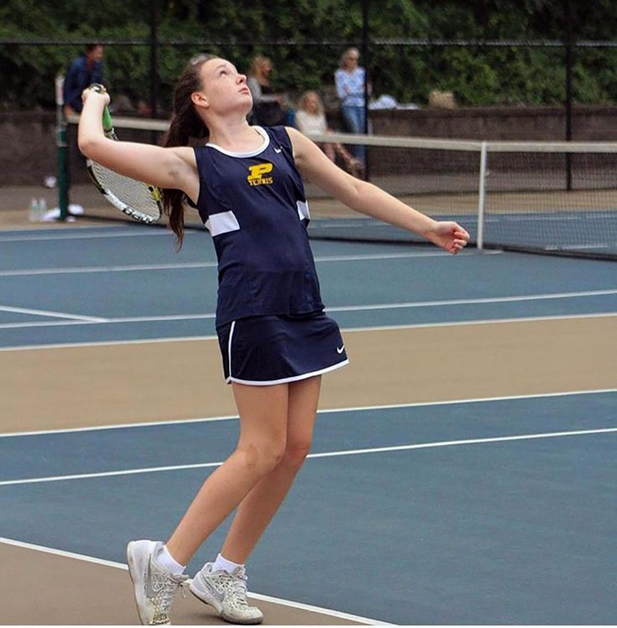 Junior Catherine Taubner serves the ball with intense concentration.