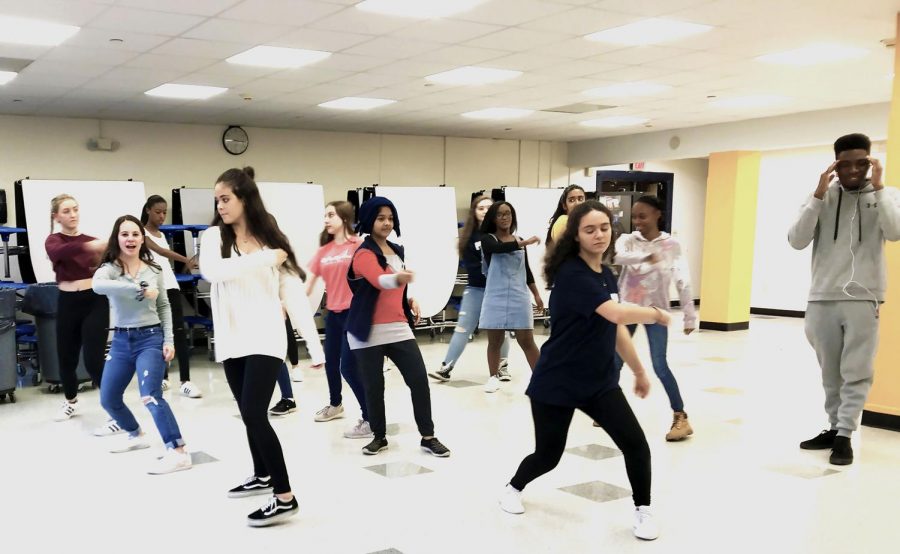Dance club members rehearse a pop routine after school.