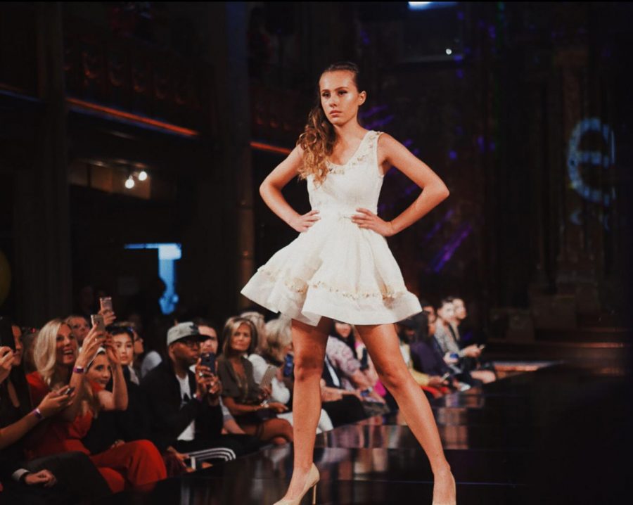 Sophomore+Julia+Corso+struts+down+the+runway+at+Art+Hearts+fashion+show.