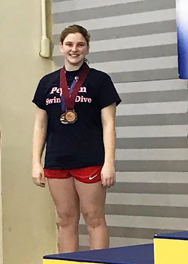Jen Bell smiles on the podium at the New York State Swimming Championships.