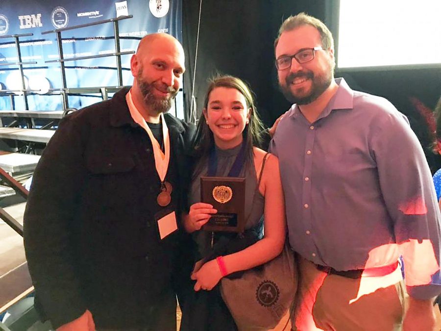Junior Isabelle Anderson celebrates her first place win in Behavioral and Social Sciences with Mr. Beltecas and Mr. DiBello.