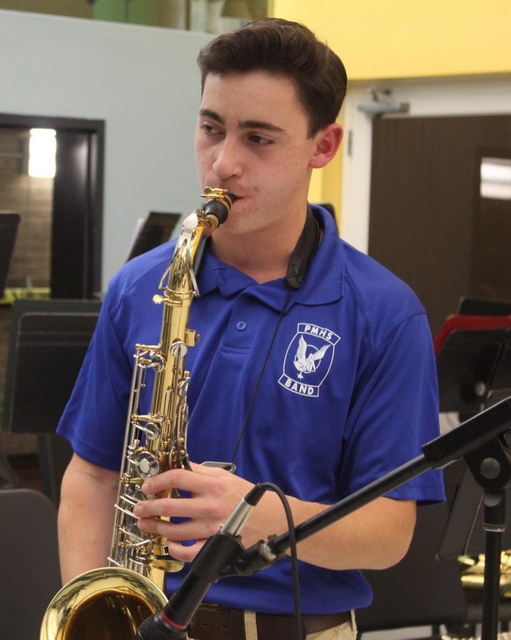 Senior Stephen Tahbaz plays his saxophone to raise money.