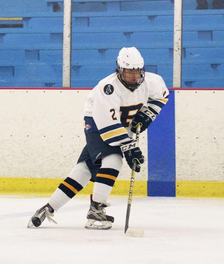 Senior Nic Franchini skates up the rink to meet his 
opponent and defend Pelham’s goals.