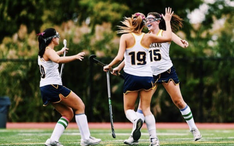 (l to r) Senior Grace Liberatore, juniors Alex Orlando, and Jane Dunbar celebrate after a goal.