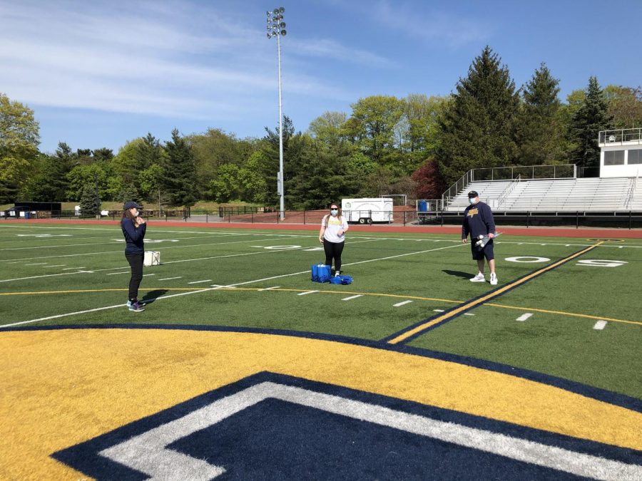 PGVL coaches Kayleigh Howe and Monica Mullen and Athletic Director Steve Luciana on Glover Field setting up to honor PGVL seniors on May 14, 2020. 