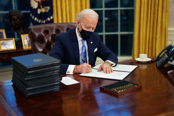 President Biden signs an executive order as he gets to work pushing his agenda on the environment and other issues.