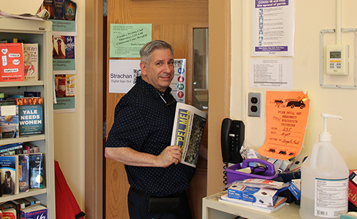 Mr. Schleifer grabs a copy of The Pel Mel as he moves on.